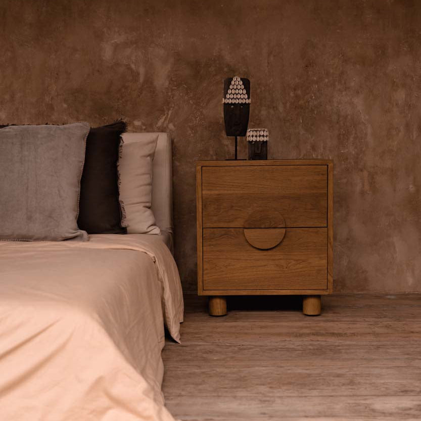 Bedroom with wooden nightstand and textured wall