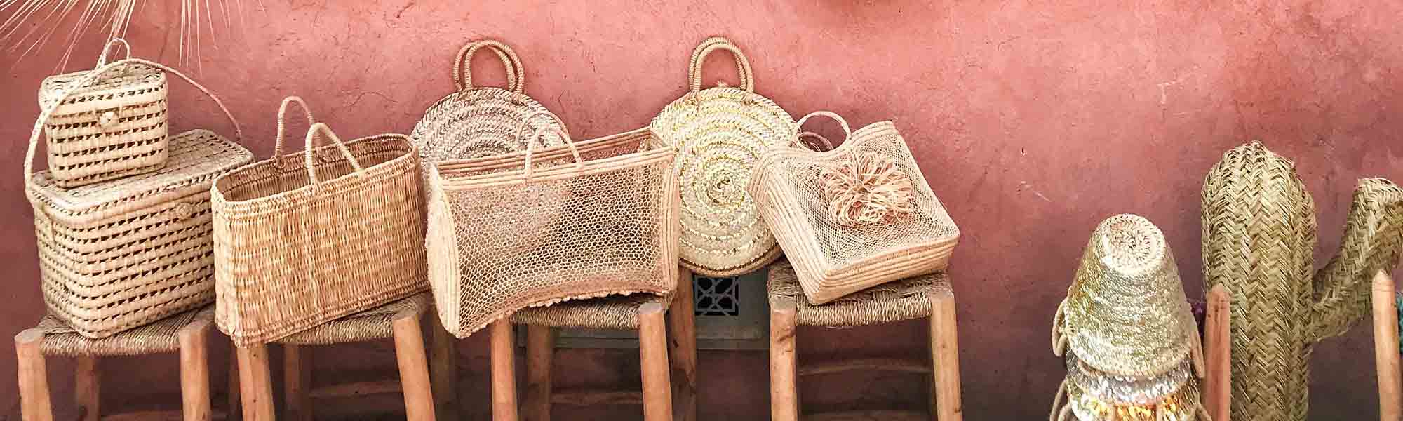 Wonderful wicker baskets on stools against a cobblestone wall