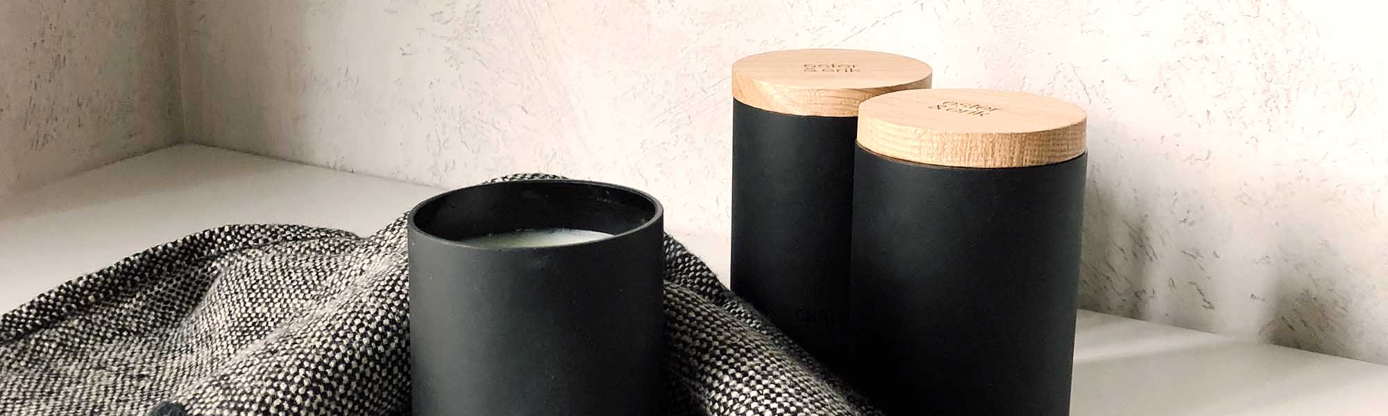 Candles in black stylish cylinder candle holders