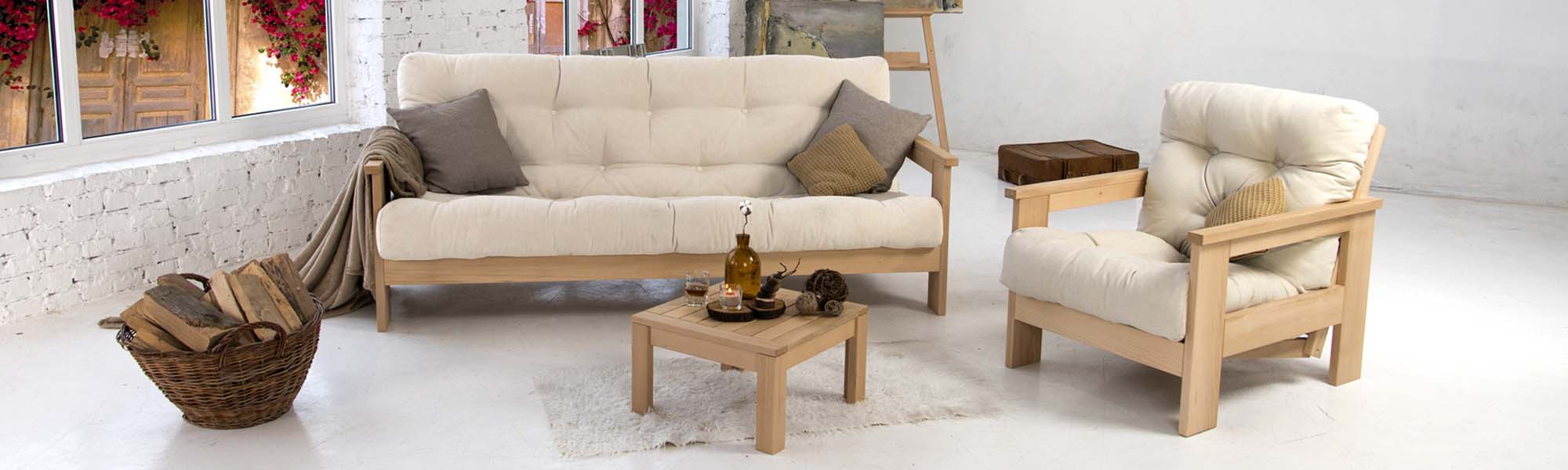 A wooden sofa, an armchair in cream upholstery and a coffee table in a spacious living room