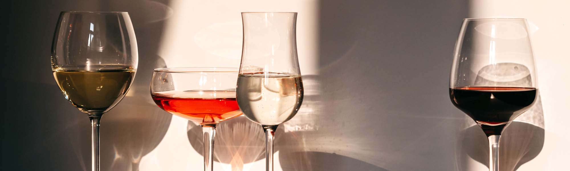 Different glasses with wine and other drinks