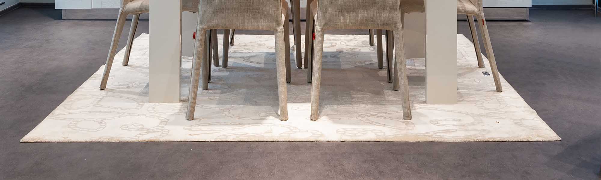 A beige kitchen mat on which the dining table stands