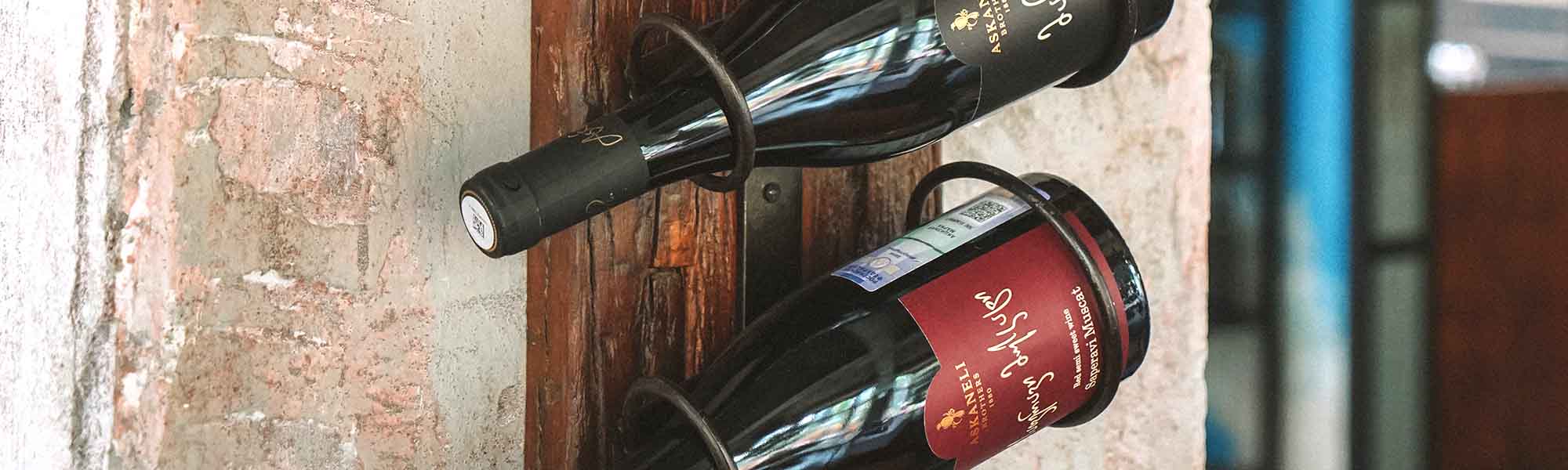 Two bottles of wine on wine racks