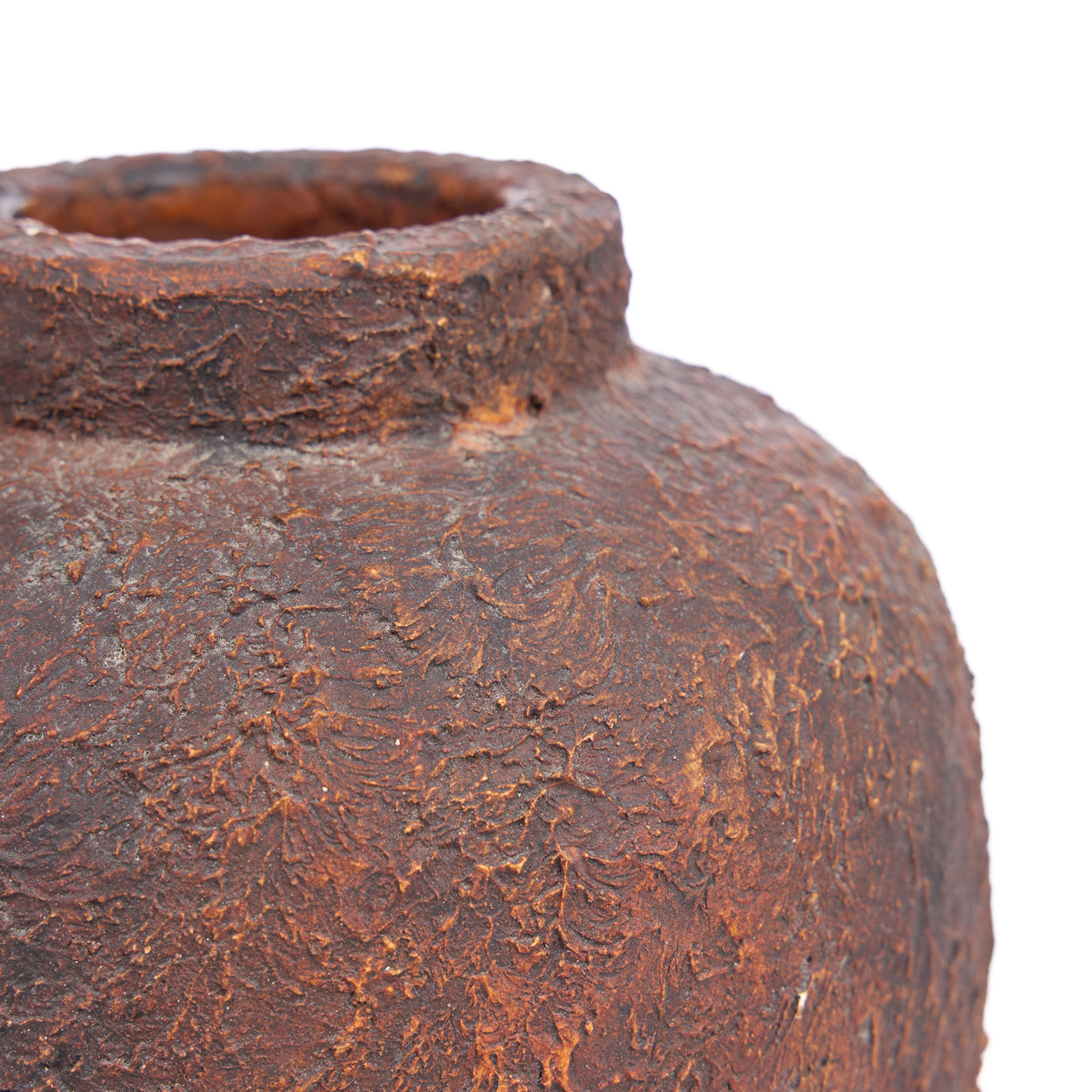 Rust-colored vase with textured surface on a white background