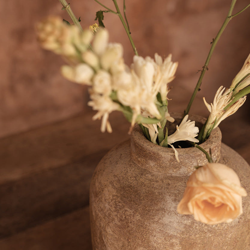 Vase with flowers on a wooden surface