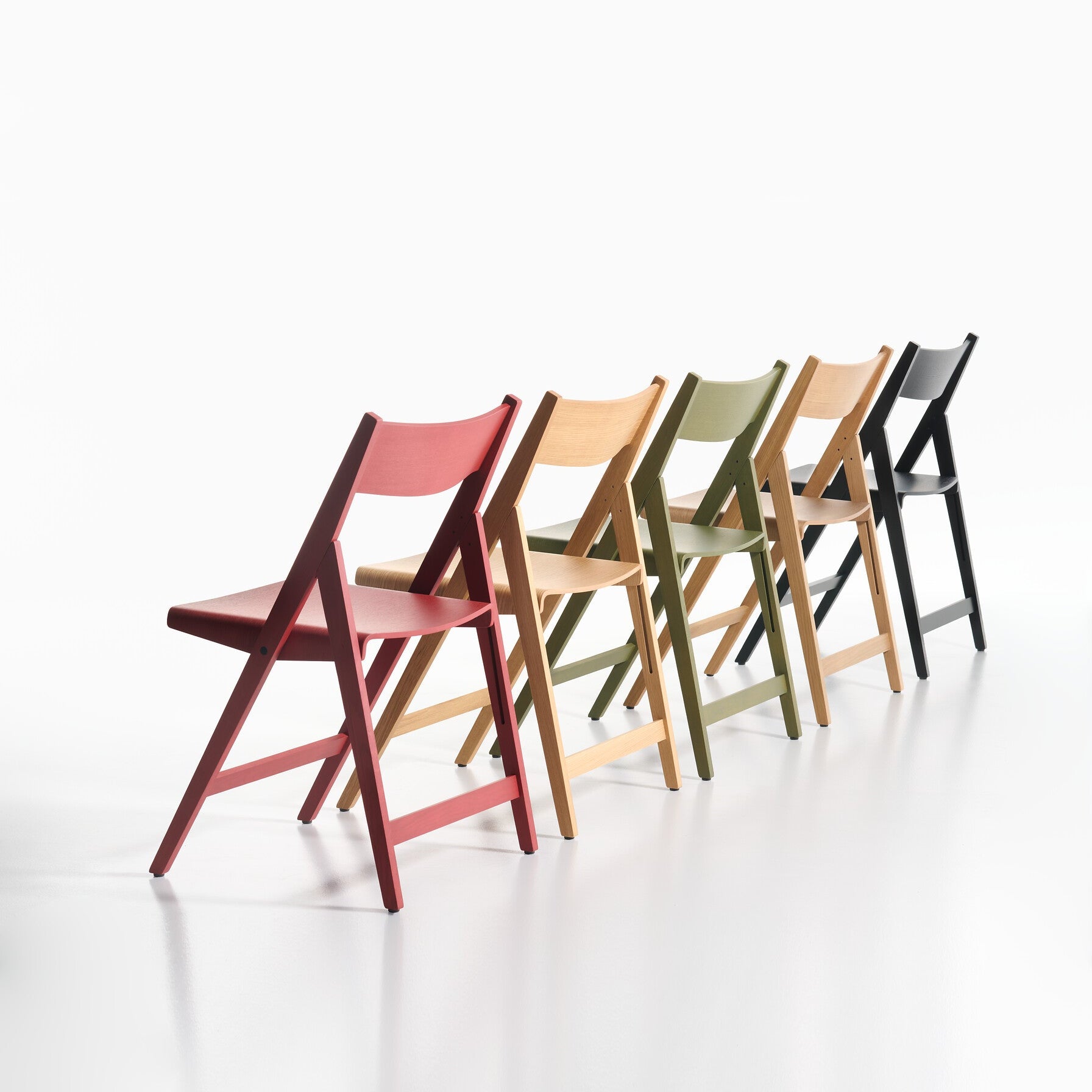 Five colorful THEO chairs arranged in a row on a white background